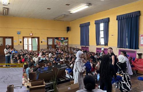  smiling students on stage